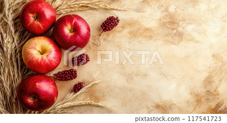 Sukkot themed background with apples, wheat, and pomegranates for holiday design 117541723