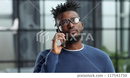 business people, communication and technology concep african american businessman calling on smartphone at office business people, communication and technology concep african american businessman calling on smartphone at office 117541730