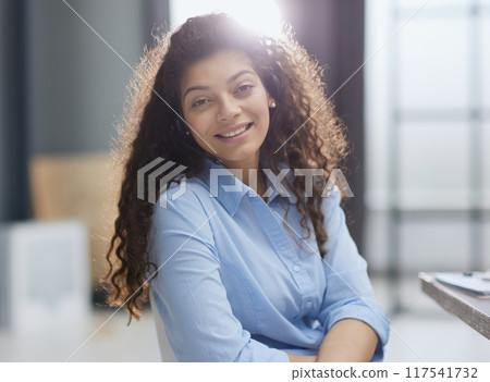 Happy businesswoman call center agent looking at camera at workplace 117541732