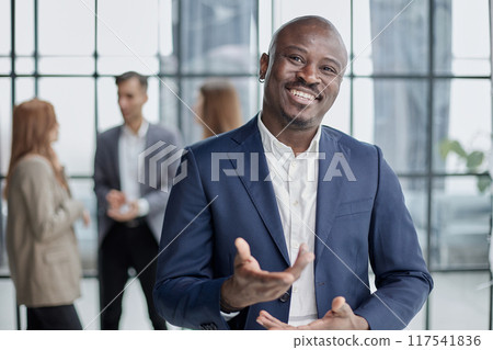 Handsome african american executive businessman in modern office Handsome african american executive businessman in modern office 117541836