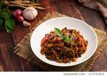 Stir fried spicy grilled sting ray with Thai red curry paste in white plate Stir fried spicy grilled sting ray with Thai red curry paste in white plate 117541925