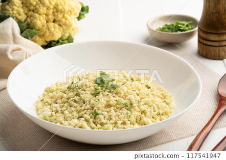 Cauliflower rice in white plate.Low carb diet, healthy eating and low calories food. 117541947