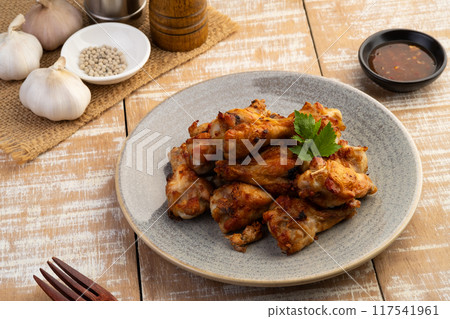 Air Fryer drummet chicken wing with garlic and pepper in a plate.Healthy oilless cooking menu. Air Fryer drummet chicken wing with garlic and pepper in a plate.Healthy oilless cooking menu. 117541961
