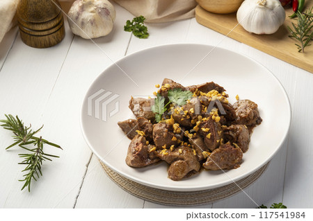 Fried chicken Liver with Garlic,Stir fry sliced liver with peppercorn and garlic in white plate. 117541984
