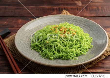 Cooked jade noodles or egg green noodle,topping with crispy garlic in a plate.(ba mee yok noodles) Cooked jade noodles or egg green noodle,topping with crispy garlic in a plate.(ba mee yok noodles) 117542010