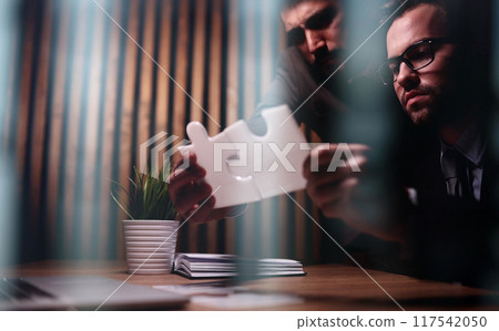 Business teamwork with white puzzle pieces cooperation unity concept Business teamwork with white puzzle pieces cooperation unity concept 117542050