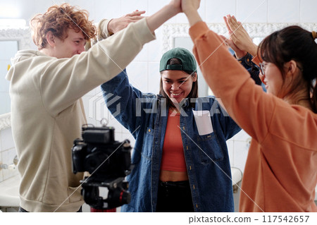 Celebrating Success During Filming Session with Friends Celebrating Success During Filming Session with Friends 117542657