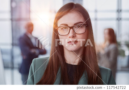 Portrait, Professional and confident millennial businesswoman or female executive manager in formal suit and eyeglasses 117542722