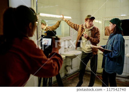 Filming Actors Discussing Scene in Bathroom 117542740