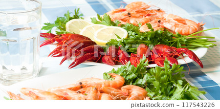 Cooked shrimp and crayfish on plate close up Cooked shrimp and crayfish on plate close up 117543226