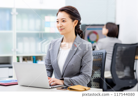 Middle woman working in the office Middle woman working in the office 117544080