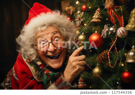 Christmas Magic: Joyous Elderly Woman Adorns Tree Christmas Magic: Joyous Elderly Woman Adorns Tree 117544356