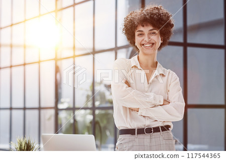 girl in the office smiles expresses success and leadership 117544365