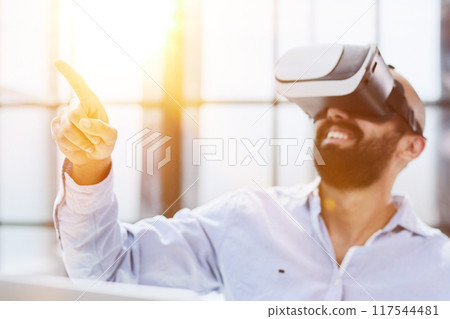 man wearing 3D glasses in the office man wearing 3D glasses in the office 117544481