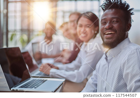 Multiethnic business people working together in the office Multiethnic business people working together in the office 117544507