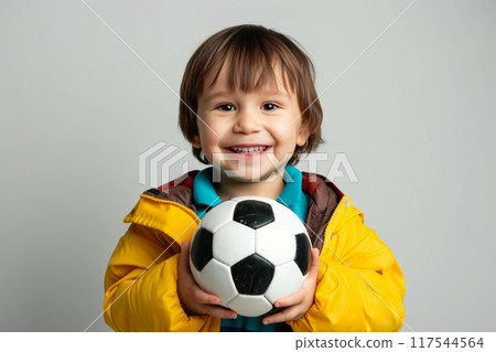 Cheerful Kid with White Teeth, Embracing Soccer Sphere in Isolation 117544564