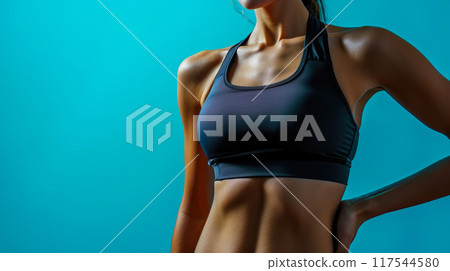 Fitness Elegance: Isolated Sportswear Portrait on Blue Fitness Elegance: Isolated Sportswear Portrait on Blue 117544580