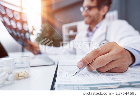 doctor making notes or recipe with pencil pen and paper for patient nurse close up. medical hospital 117544695