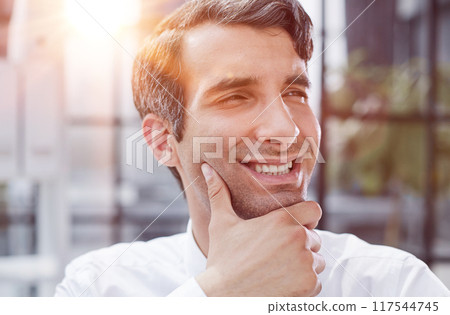 close-up, portrait of a serious businessman on the background of the office close-up, portrait of a serious businessman on the background of the office 117544745