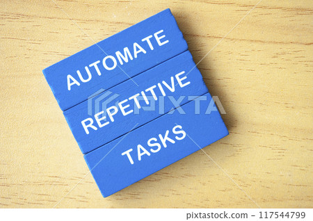 Top view of Automate repetitive tasks text on blue wooden blocks. Business improvement concept. 117544799