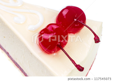Delicious slice of cheesecake topped with sweet cherries on a white background 117545073