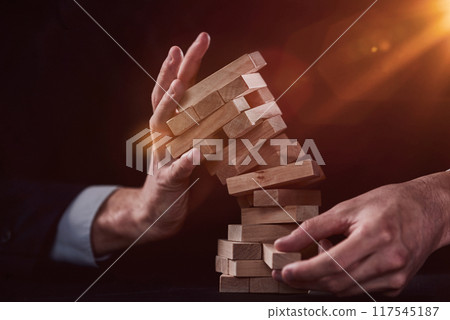 Plan and strategy in business, Risk To Make Business Growth Concept With Wooden Blocks, hand of man has piling up and stacking a wooden block. 117545187
