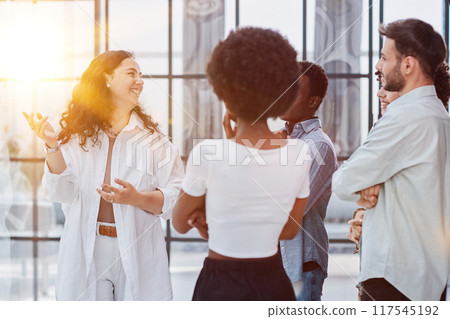 business woman with her staff in background at office business woman with her staff in background at office 117545192