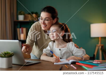 Girl doing homework or online education. 117545515