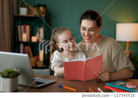 Girl doing homework or online education. Girl doing homework or online education. 117545518