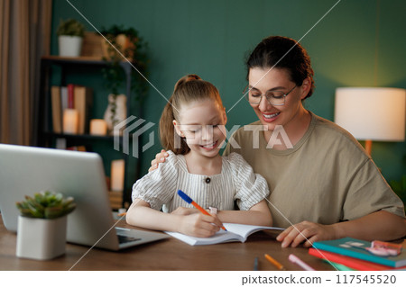 Girl doing homework or online education. Girl doing homework or online education. 117545520