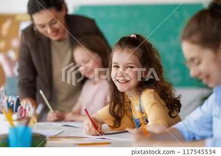 Happy kids and teacher at school 117545534