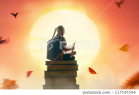 child on the tower of books child on the tower of books 117545594
