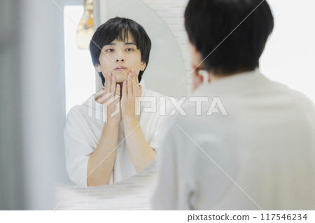 Man doing skin care in the bathroom 117546234