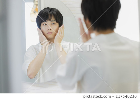 Man doing skin care in the bathroom 117546236