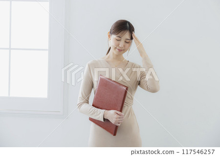 Businesswoman holding a file Businesswoman holding a file 117546257