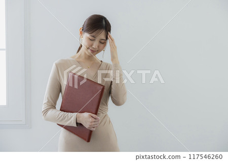 Businesswoman holding a file Businesswoman holding a file 117546260