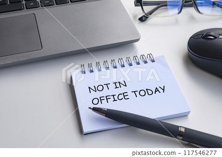 Not in office today text on with notepad with office background. Out of office concept. Not in office today text on with notepad with office background. Out of office concept. 117546277