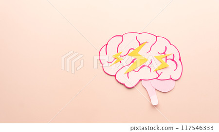 Brain anatomy with thunderbolt flashes made form paper on cream background. Creative idea for headache, stress, emotional exhaustion, depression, anger and anxiety emotion. Brain anatomy with thunderbolt flashes made form paper on cream background. Creative idea for headache, stress, emotional exhaustion, depression, anger and anxiety emotion. 117546333