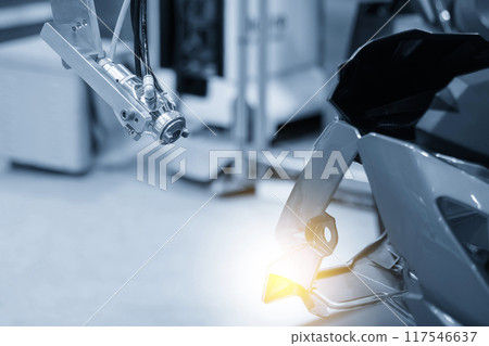 Close up scene the automatic painting robot working with automotive parts. Close up scene the automatic painting robot working with automotive parts. 117546637
