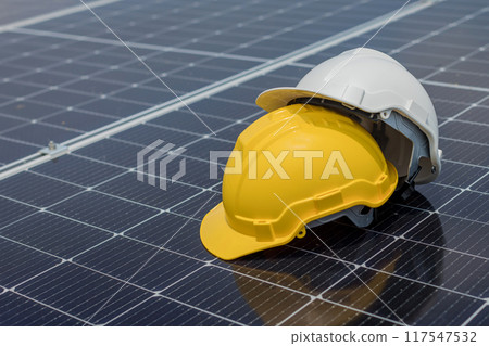 safety helmet on solar panel. concept clean energy power in nature 117547532
