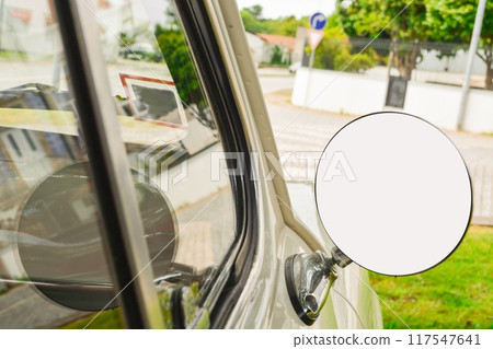 Close-up of a round mirror in a silver retro car with a place for a signature on the mirror. Concept of love for luxury, old money style with a mockup. 117547641