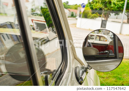 Close-up of a round mirror in a silver retro car with a pestle for signature on the mirror. Concept of love for luxury, old money style 117547642