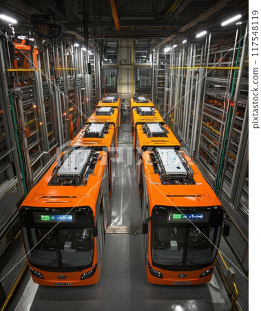 Orange electric buses on production line, showcasing public transport innovation. 117548119