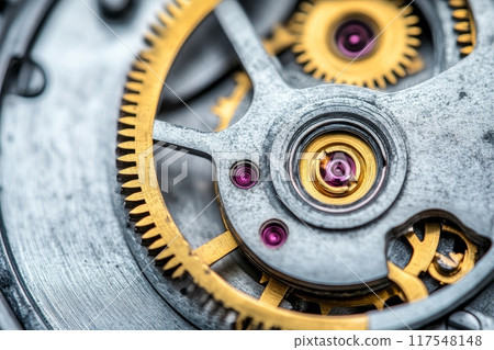 Macro shot of a watch mechanism showing intricate gears, jewels, and metallic components. 117548148