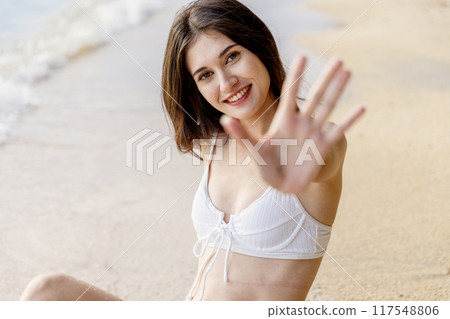 Beautiful girl on sun tanning in a tropical beach. Beautiful girl on sun tanning in a tropical beach. 117548806