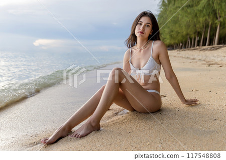 Beautiful girl on sun tanning in a tropical beach. Beautiful girl on sun tanning in a tropical beach. 117548808