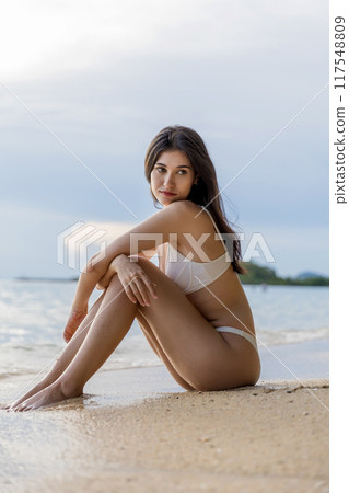 Beautiful girl on sun tanning in a tropical beach. Beautiful girl on sun tanning in a tropical beach. 117548809