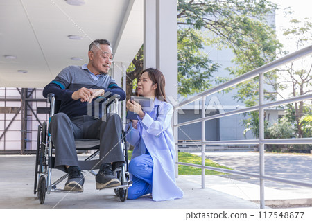 Doctor or Caregiver nurse take care a Senior patient sit on wheelchair. Doctor or Nurse helping senior Man 117548877