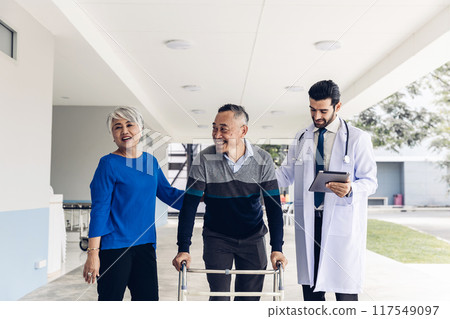 doctor helping Senior man to walk at nursing home with walker 117549097