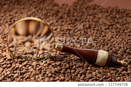 Coffee beans under a magnifying glass. Coffee beans under a magnifying glass. 117549726